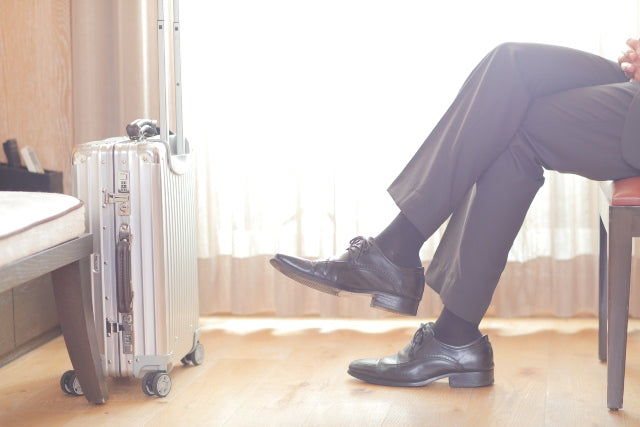 man wearing flight socks with his business suit