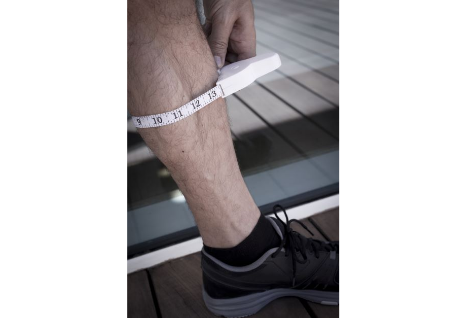 man measuring calf