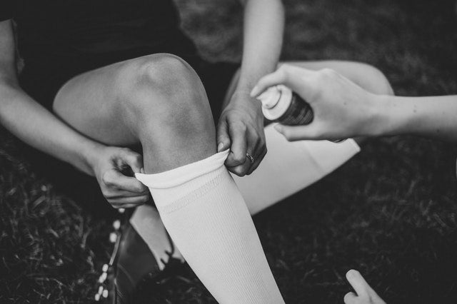 Athlete putting on compression socks