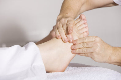 nurse examining a patient's foot